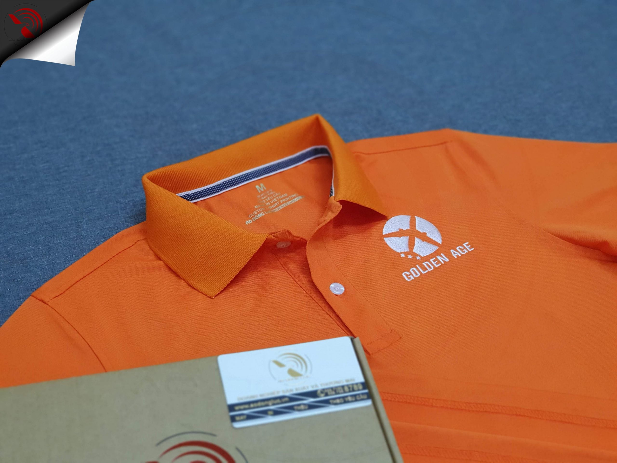 Đồng phục áo thun polo bo trơn màu cam thêu logo